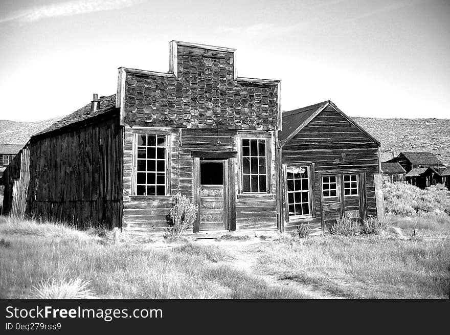 Gray Scale Photo of Brown Wooden House during Daytime