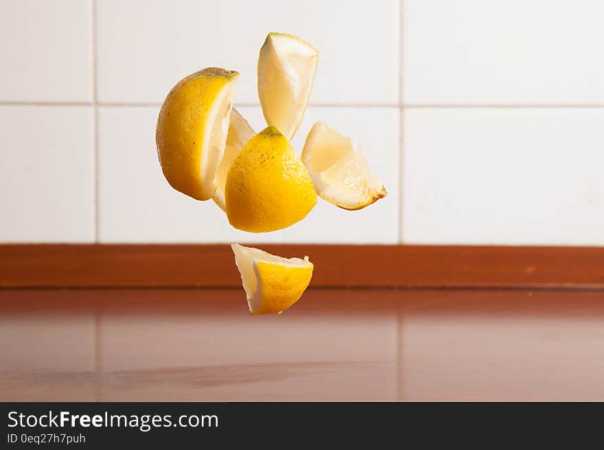 Levitating pieces of lemon over kitchen counter. Levitating pieces of lemon over kitchen counter.