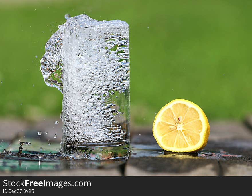 Time Lapse Photography of Water Bobbling Beside Lemon Fruit