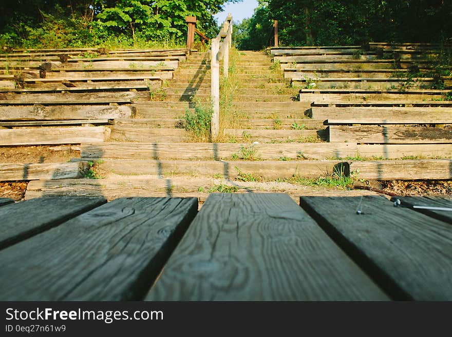 Rows of wooden seats, steps and stage in empty outdoor theater. Rows of wooden seats, steps and stage in empty outdoor theater.