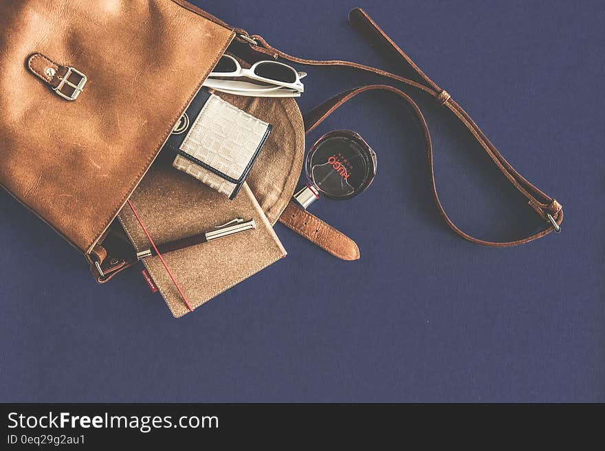 Brown Leather Crossbody Bag With White Framed Sunglasses