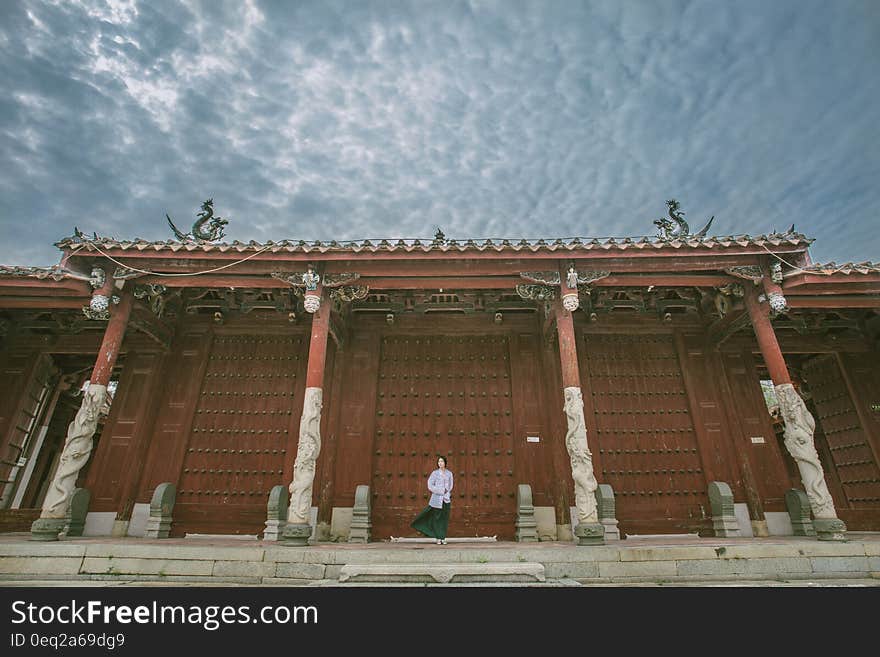 Person Standing Near Red Gate