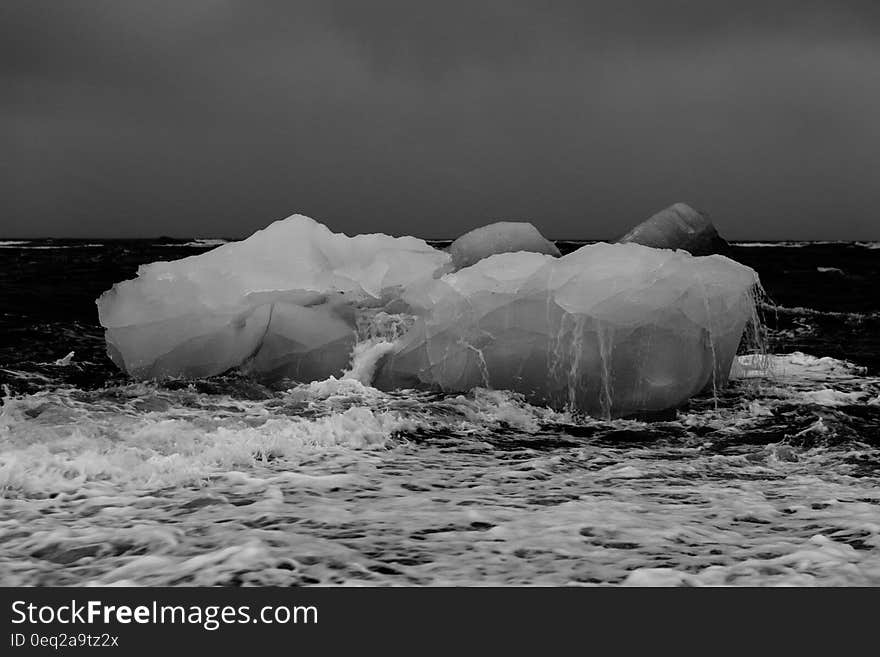 Icebergs on beach in black and white.