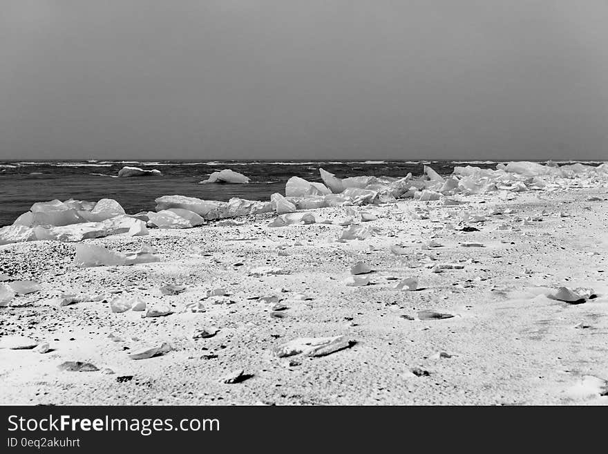 A beach with ice and snow in black and white. A beach with ice and snow in black and white.