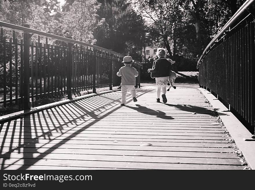 Children Running Together on Wooden Path Way Bridge