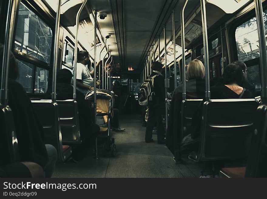 Man in White T Shirt Standing on the Bus