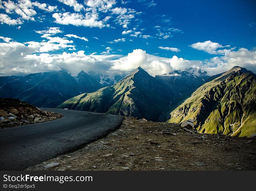 Gray Asphalt Road Near Green Fold Mountain at Daytime