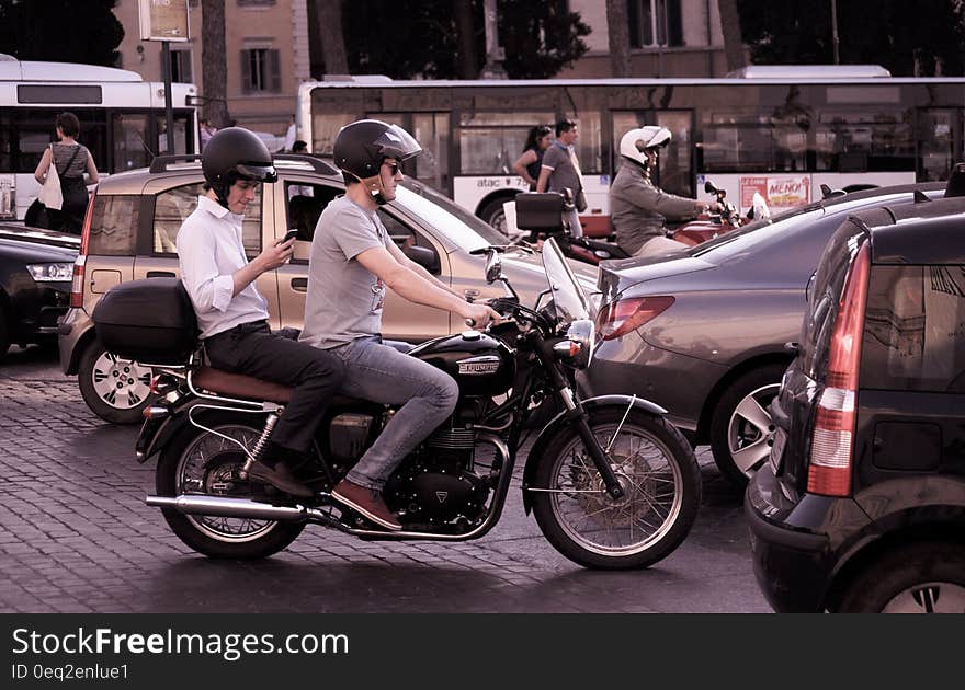 A view of a street with motor vehicles, cars and motorbikes. A view of a street with motor vehicles, cars and motorbikes.