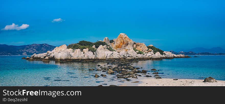 Rocky Island Surrounded by White Water