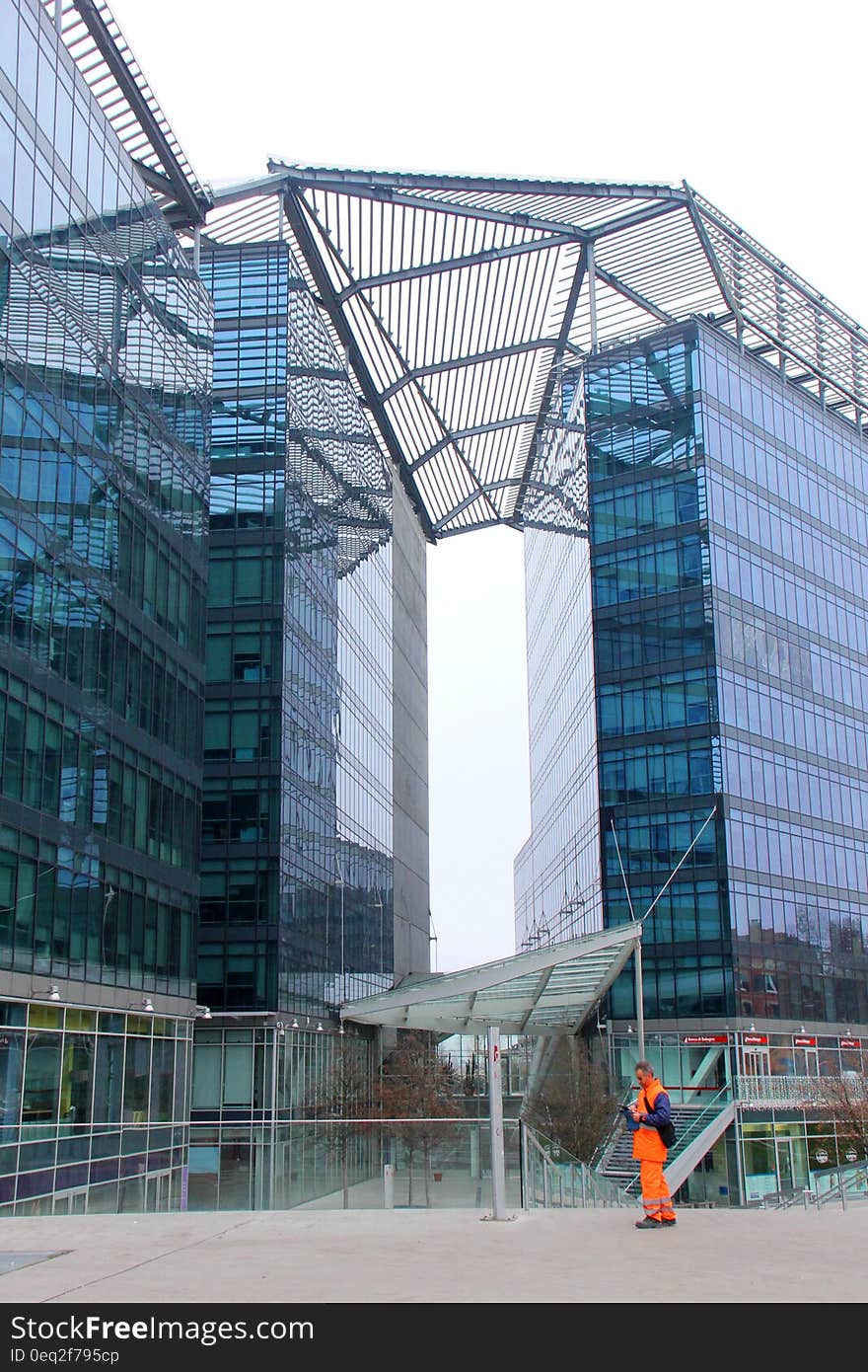 Man Standing With Background of Glass High Rise Building