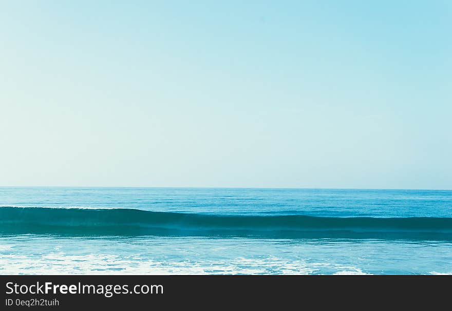 A sea wave and open sea in the background.