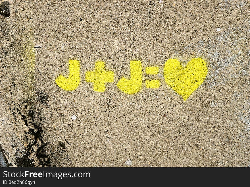 A yellow love equation on a wall. A yellow love equation on a wall.