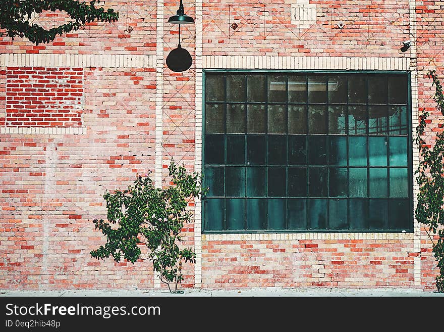 Exterior of industrial building with glass windows and brick wall. Exterior of industrial building with glass windows and brick wall.