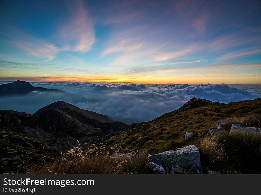 Mountains Above White Clouds Under Blue Sky