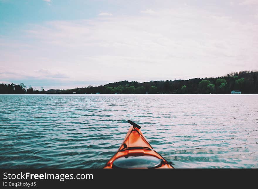 A view of the bow of a kayak on the lake. A view of the bow of a kayak on the lake.