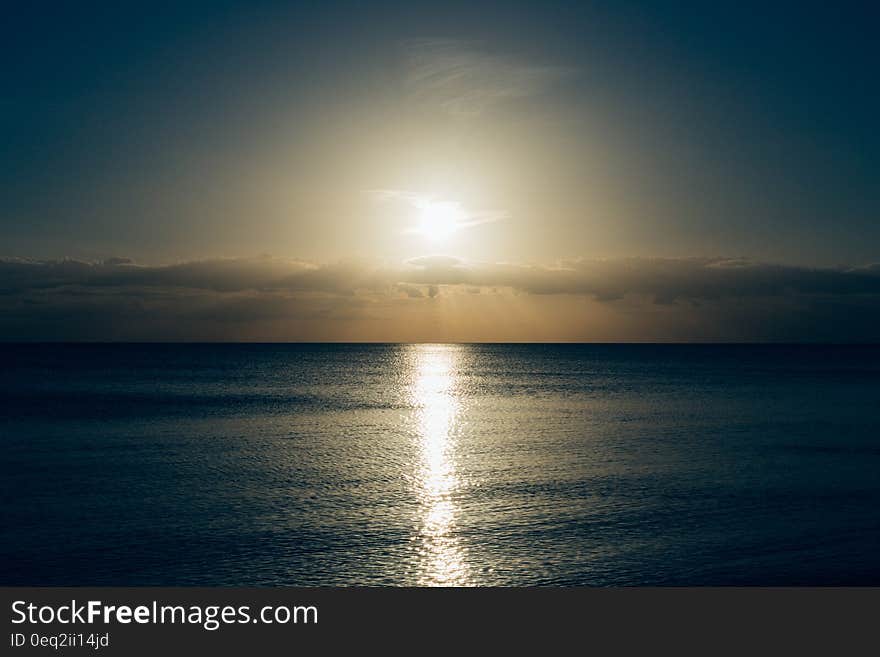 Calm Sea With Sun Setting Photo