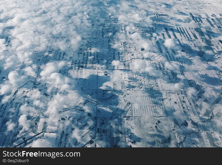 An aerial view of a rural landscape and clouds above. An aerial view of a rural landscape and clouds above.