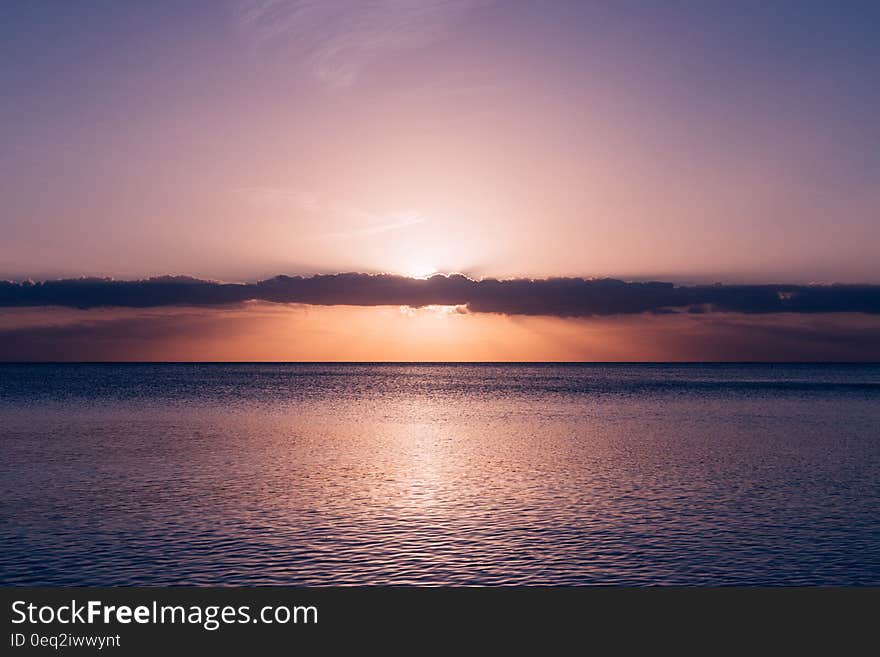 Calm Sea Under Blue Sky during Sunset