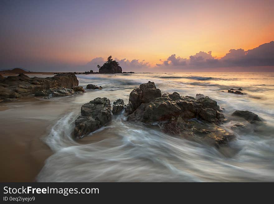 Stone in Seashore during Sunset