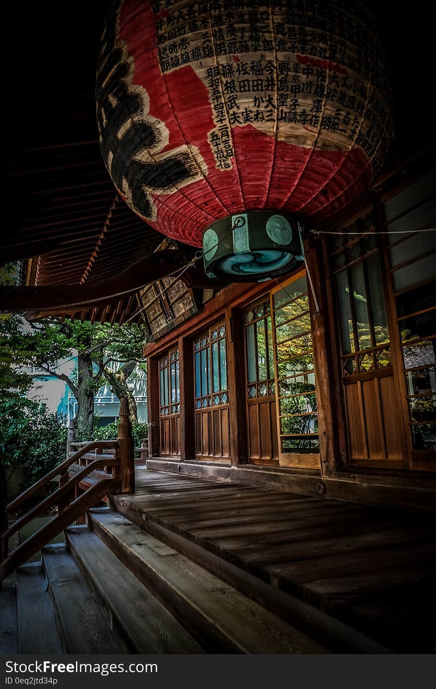 Red Green and Black Floating Lantern With Kanji Text Decoration Above Stairs