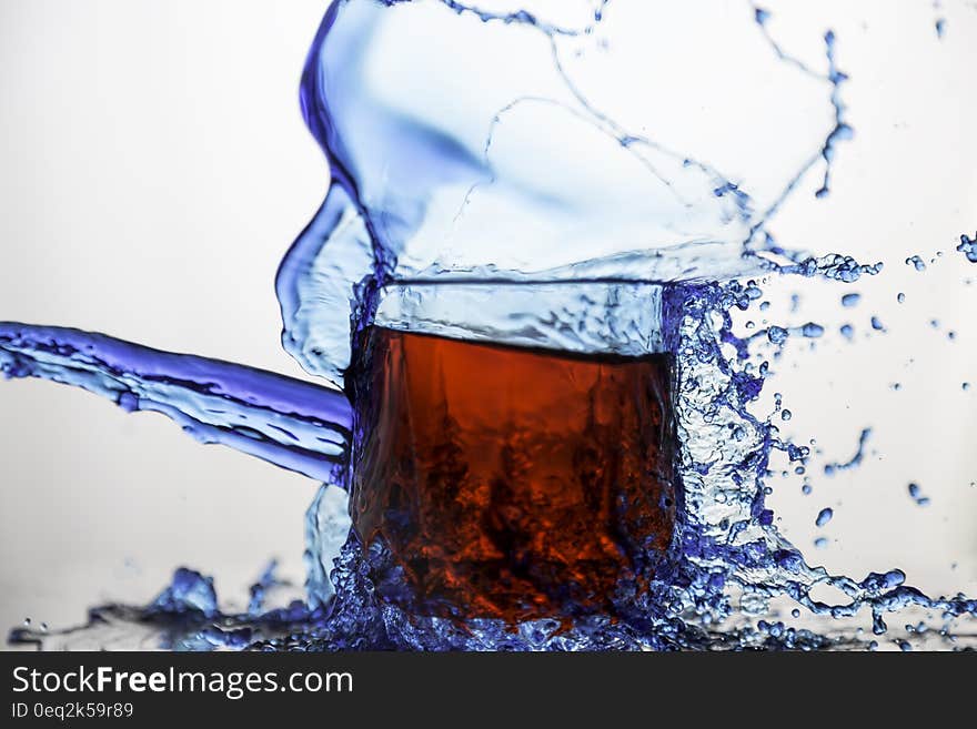 Blue Clear Glass Cup Splashed of Water