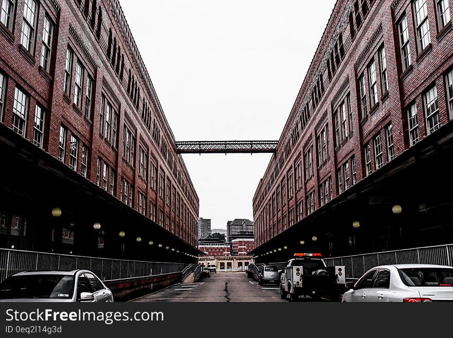 Red Painted Building With Cars Under It