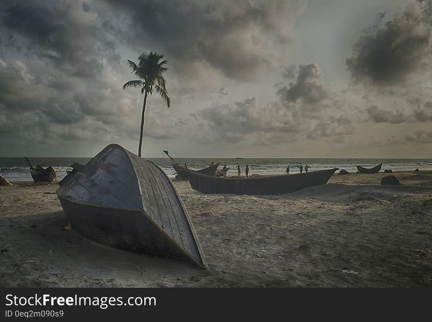 Gray Boat on Gray Sand Beach Under Gray Cloudy Sky