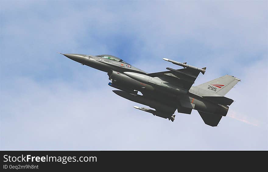 Black Jet Plane Flying Under Blue and White Sky during Daytime