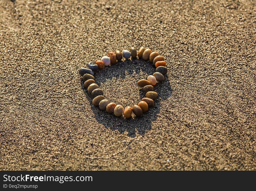 Brown and Grey Stone Formed Heart on Sand