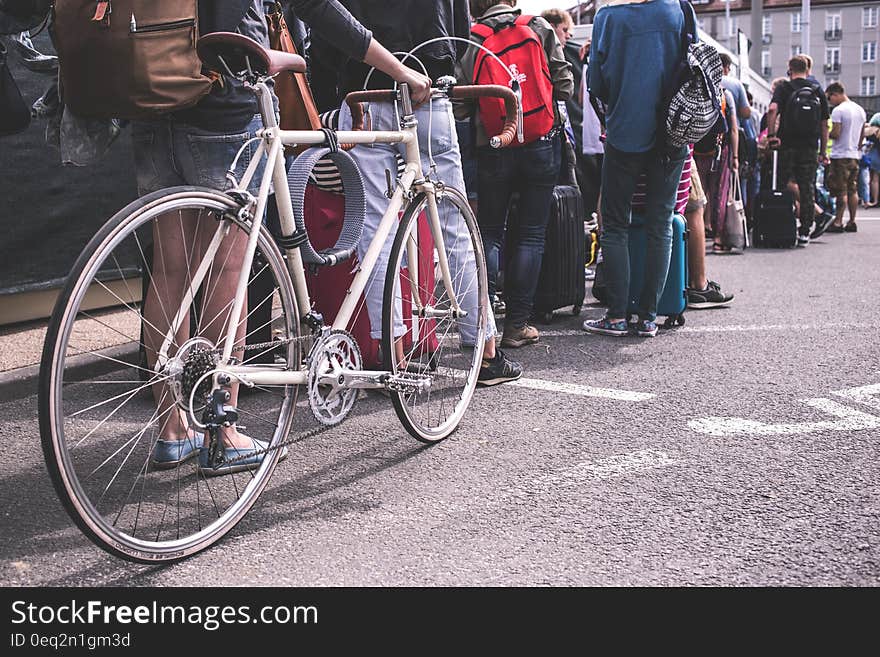 Person in Black Sweater Hold a Grey Road Bike