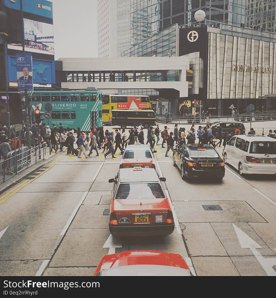 People Crossing in Pedestrian Lane in City during Daytime