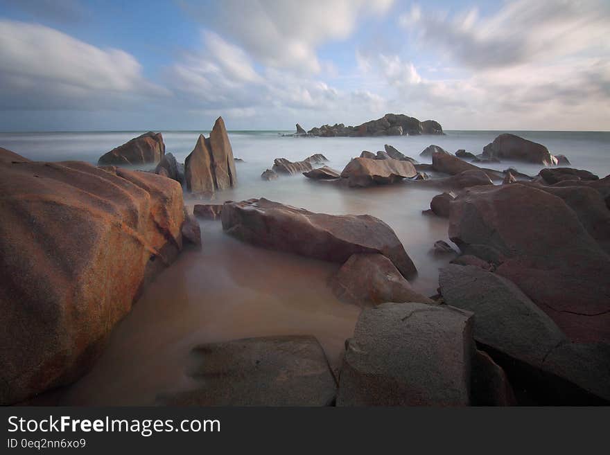 Rocks in Sea during Daytime