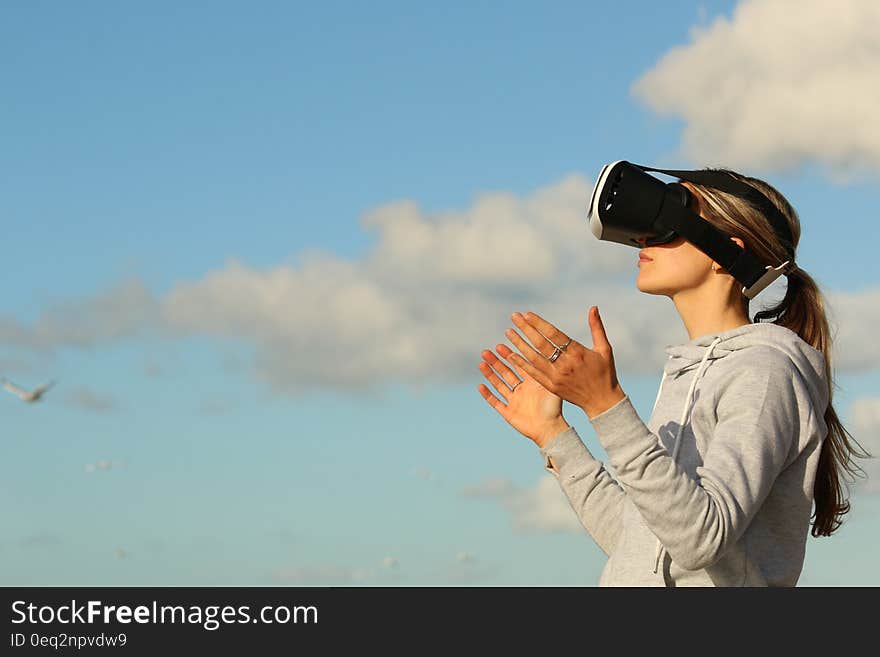 A woman outdoors with a virtual reality headset. A woman outdoors with a virtual reality headset.