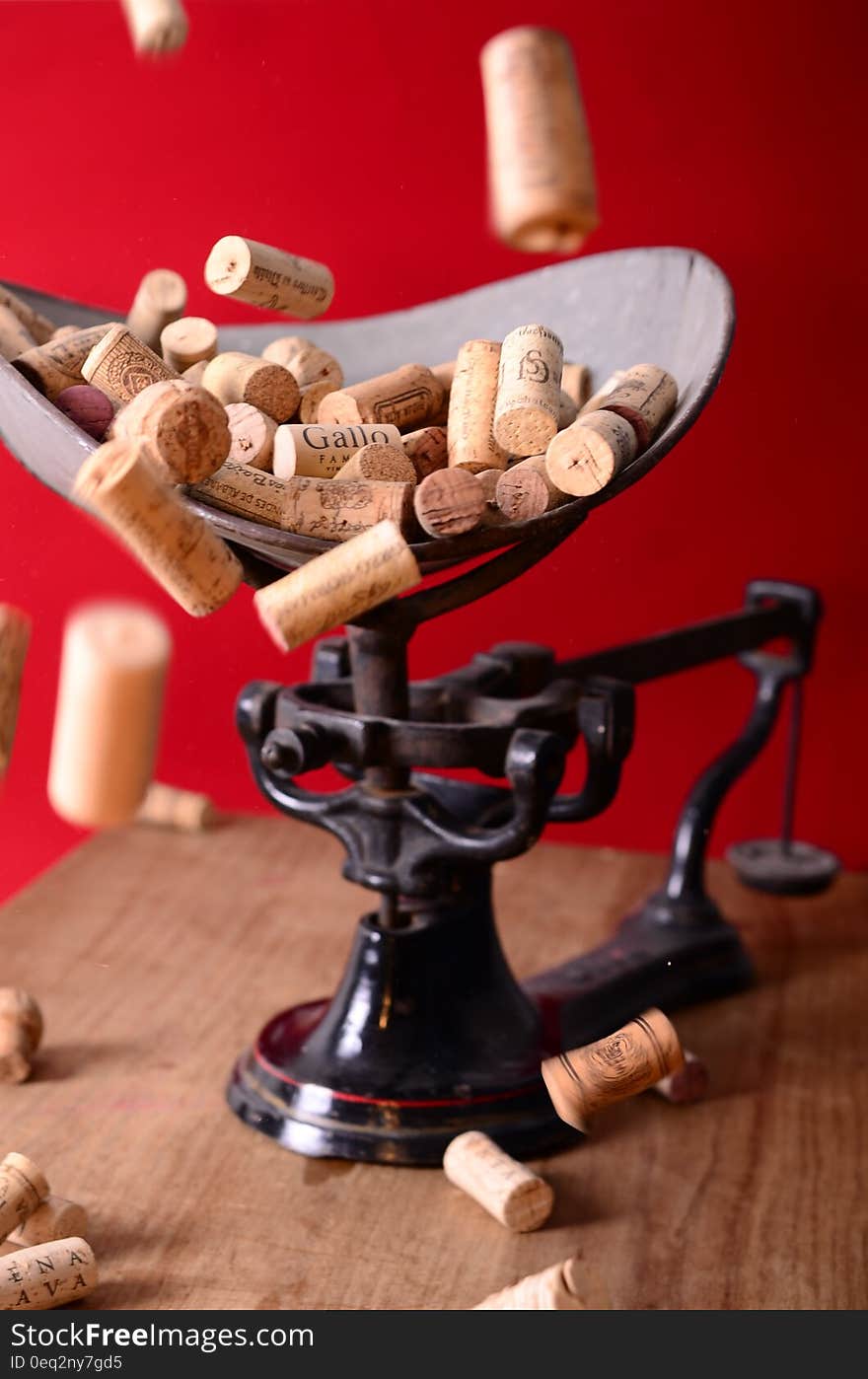 A bunch of wine bottle corks on a mechanical scale. A bunch of wine bottle corks on a mechanical scale.