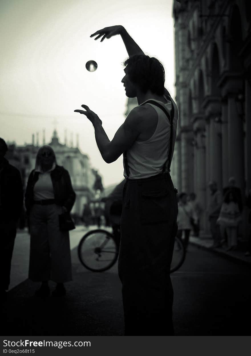 A man performing magic tricks on the street. A man performing magic tricks on the street.