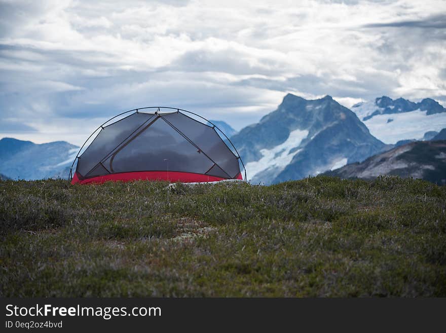 Scenic view of camping tent in snow capped mountainous landscape. Scenic view of camping tent in snow capped mountainous landscape.