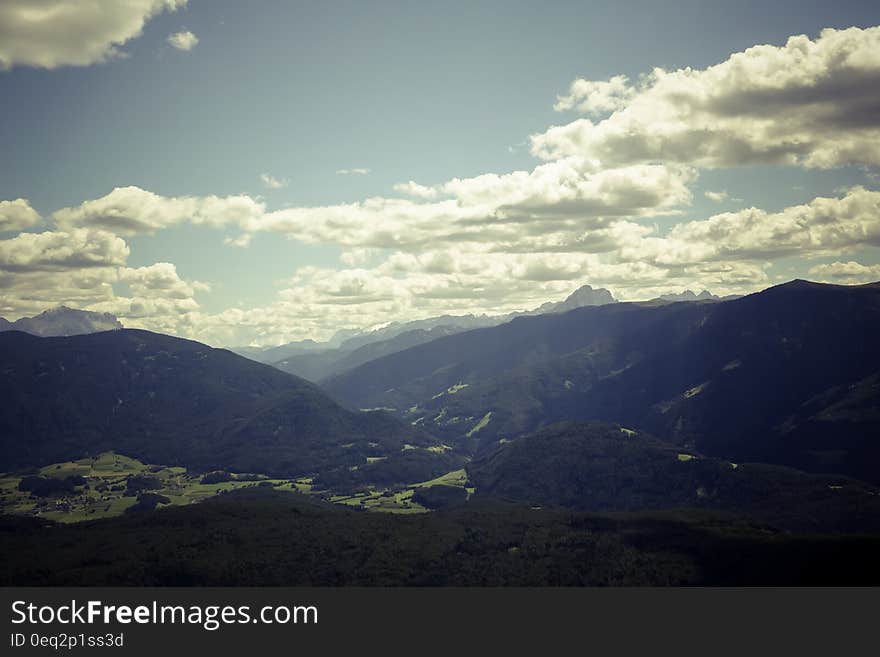 Black Mountain Range Under Gray Cloudy Sky during Daytime