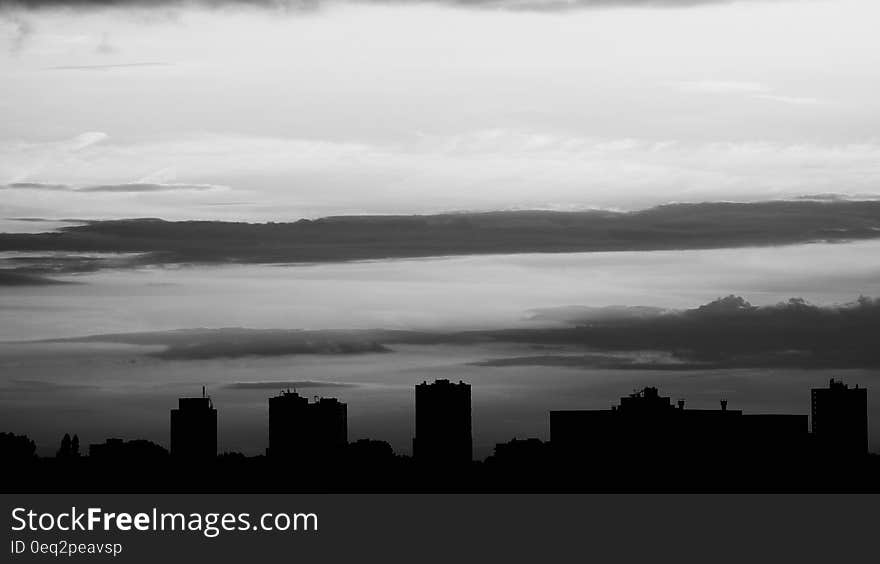 Silhouette of Buildings Under Gray Clouds