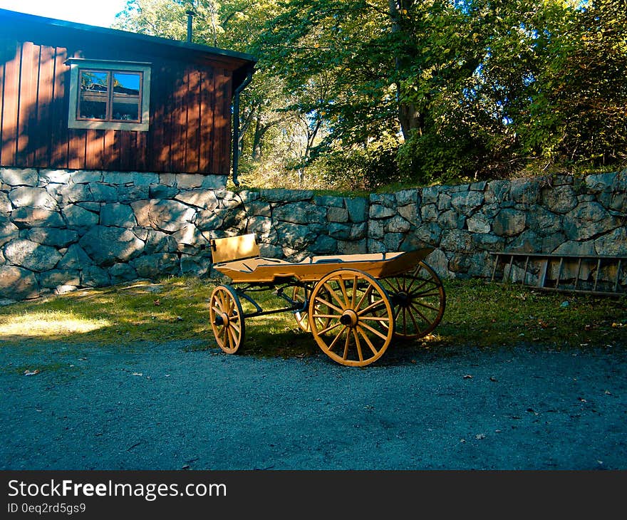 Brown Carriage on Green Grass Lawn