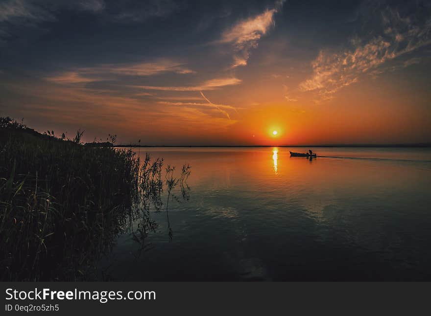 Person on a Boat Traveling during Sun Set