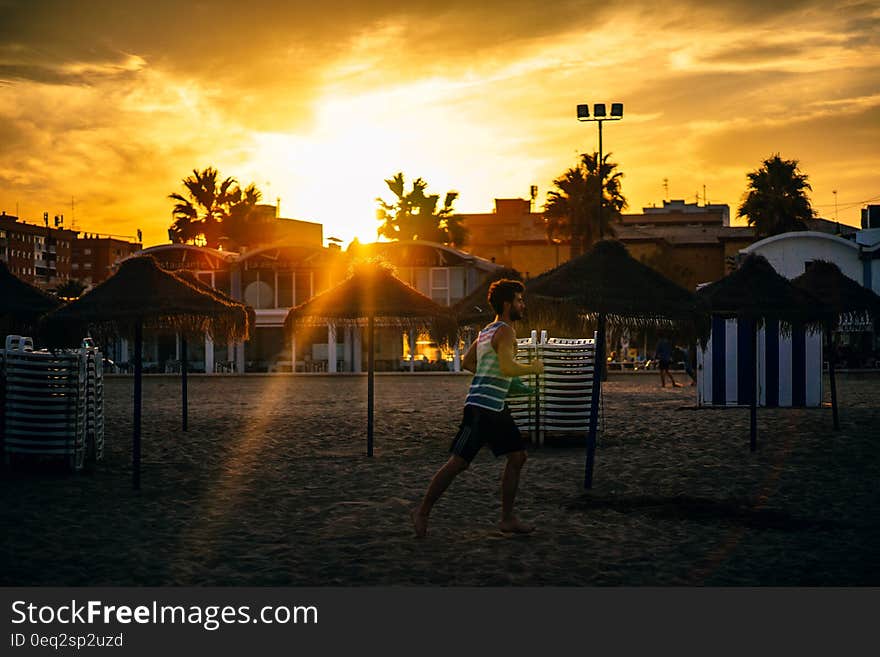 Man Running in the Beach during Sunset