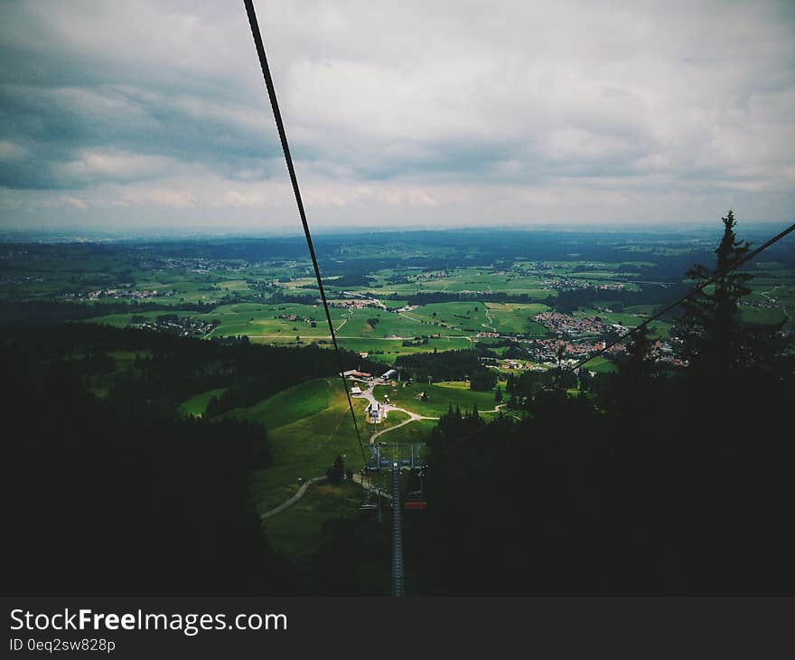 Areal View of Green Fields Under Grey Sky