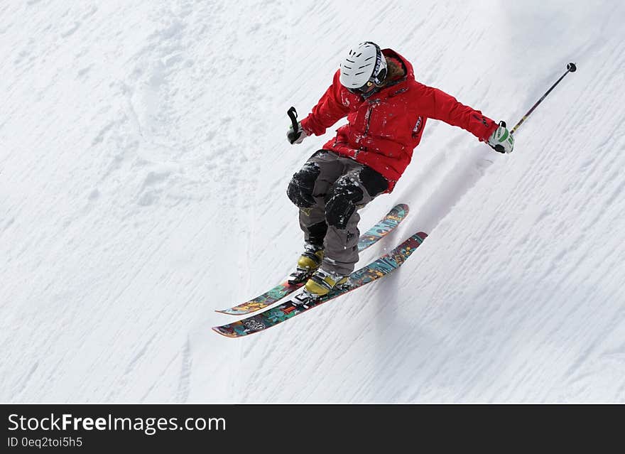 Man in Red Jacket Playing Ice Skates during Day Time