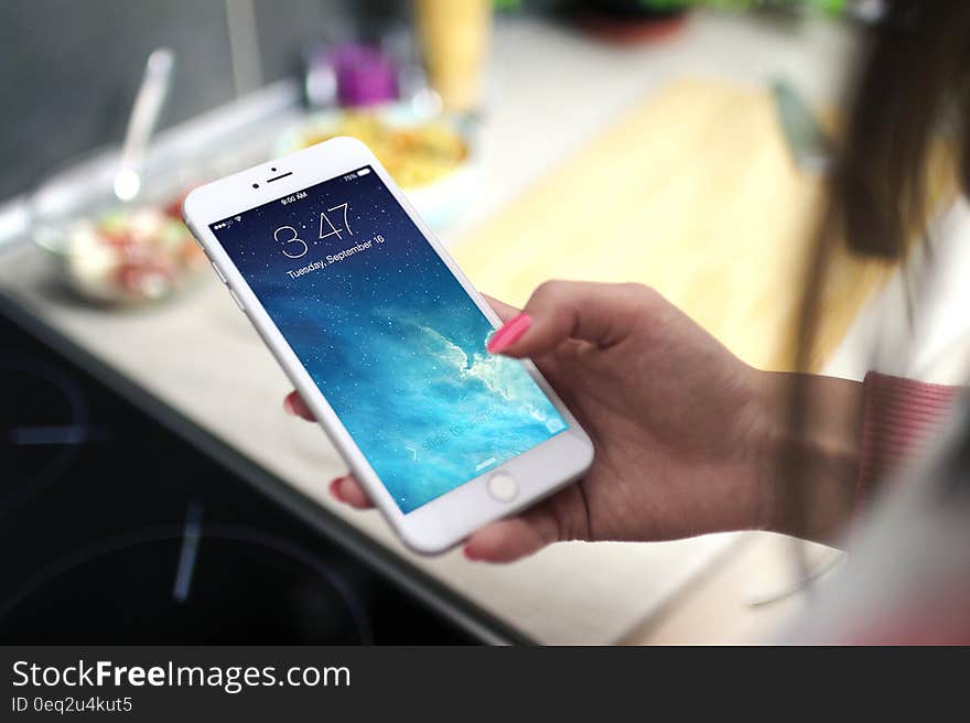 Hand of woman using touchscreen of iPhone 6. Hand of woman using touchscreen of iPhone 6.