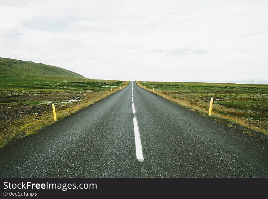 Straight asphalt road in the countryside receding into distance. Straight asphalt road in the countryside receding into distance.