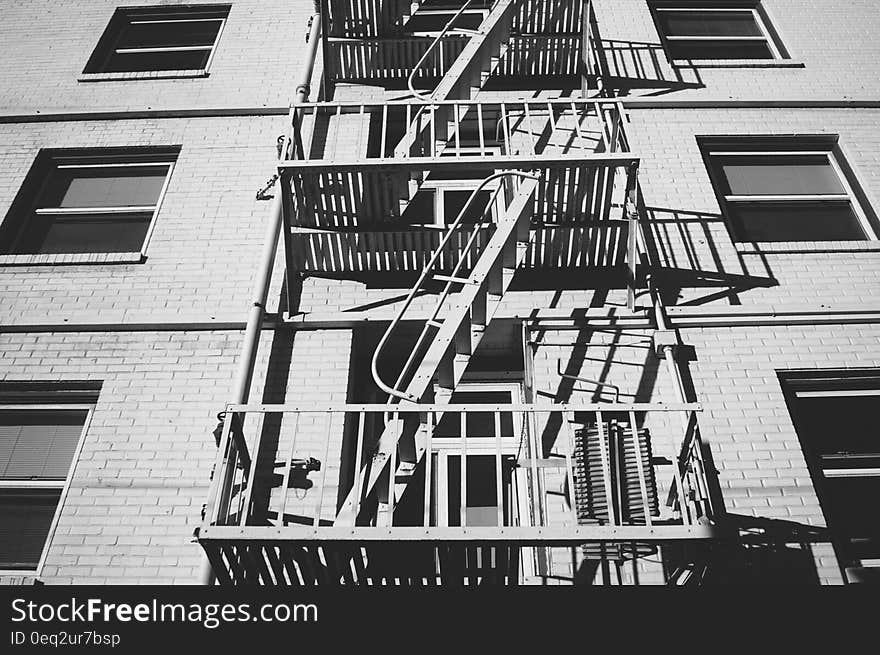 Emergency stairs seen from below in black and white.