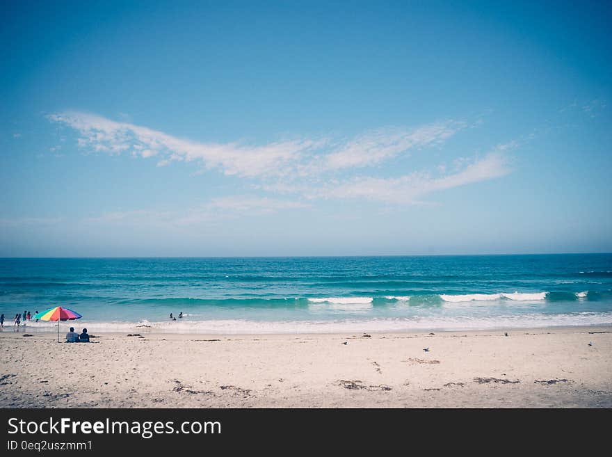 View of a beach with sand and sea. View of a beach with sand and sea