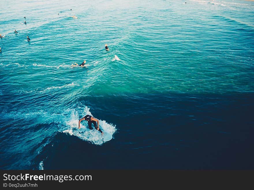 The ocean surface with swimmers and surfers on the waves. The ocean surface with swimmers and surfers on the waves.