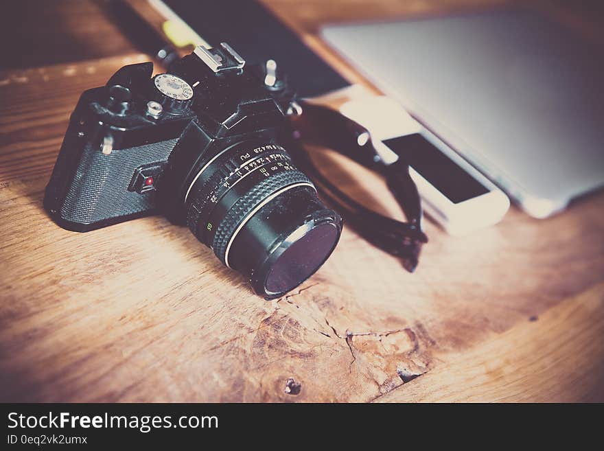 Vintage retro photo camera on desk. Vintage retro photo camera on desk