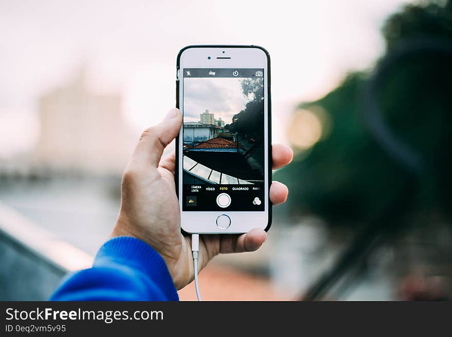 Hand holding mobile phone and taking a photo. Hand holding mobile phone and taking a photo.